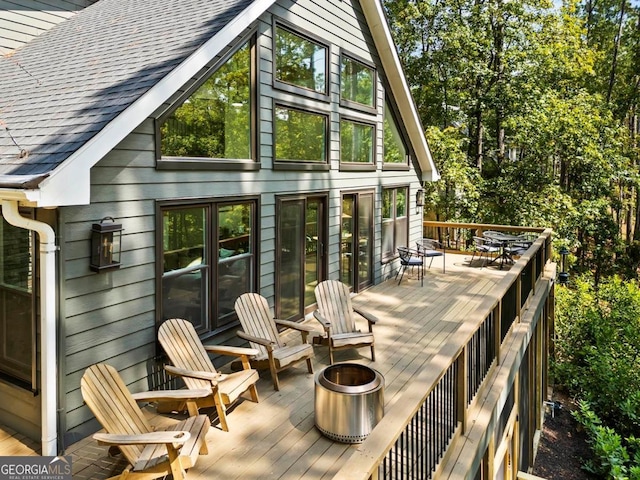 wooden terrace featuring a fire pit