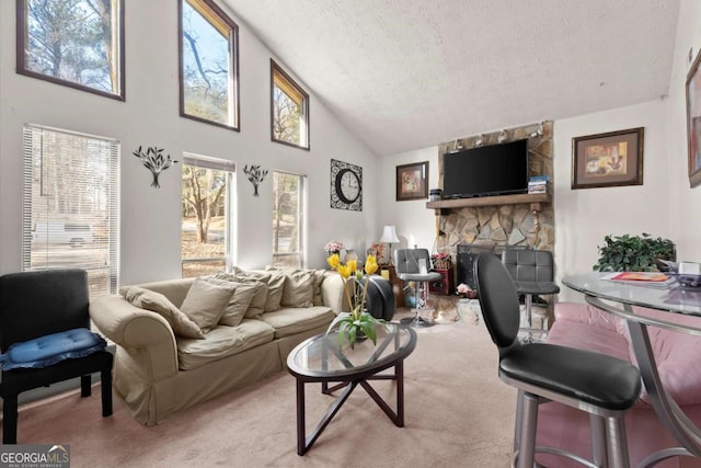 living room featuring light carpet, high vaulted ceiling, a stone fireplace, and a textured ceiling