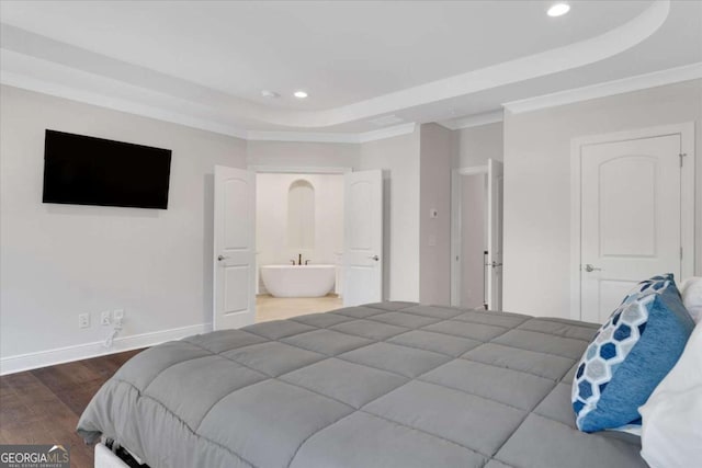 bedroom with recessed lighting, wood finished floors, baseboards, a raised ceiling, and crown molding