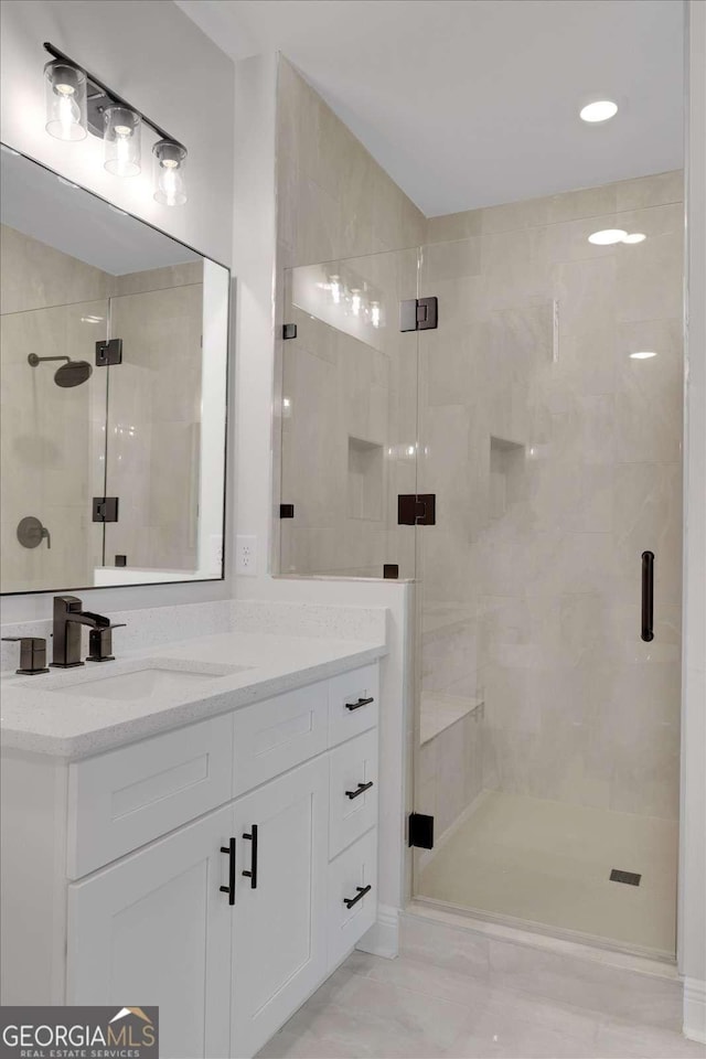 full bathroom with a shower stall and vanity