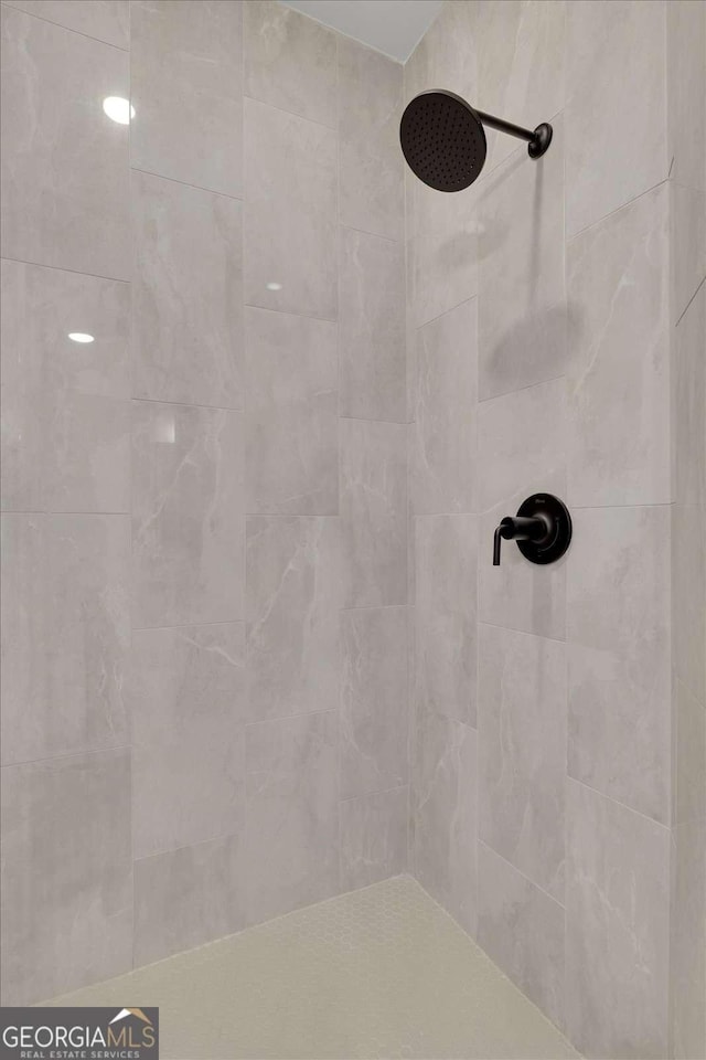 full bath with a tile shower