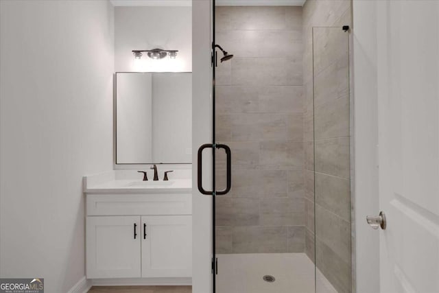 full bathroom with a shower stall and vanity