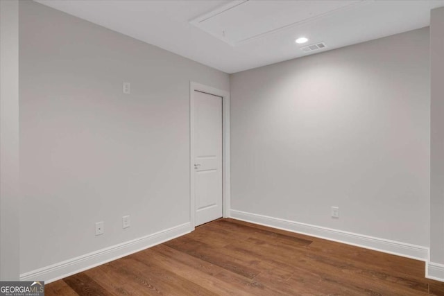 unfurnished room with visible vents, baseboards, and wood finished floors