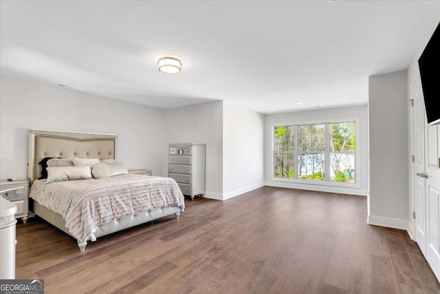 bedroom featuring baseboards and wood finished floors