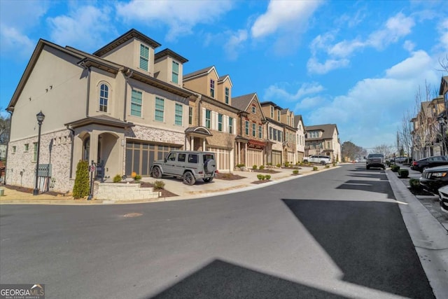 view of street featuring a residential view, curbs, sidewalks, and street lights