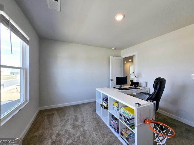 carpeted office space featuring baseboards and visible vents