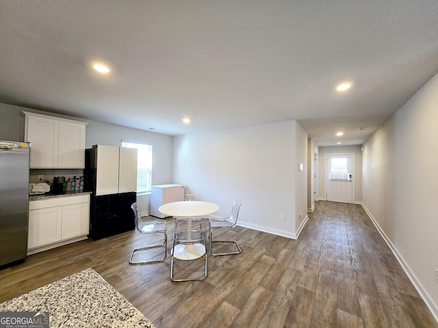 dining area with baseboards, dark wood finished floors, and recessed lighting