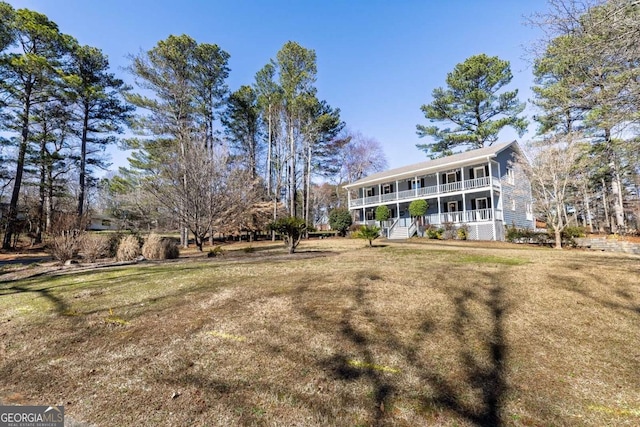 exterior space featuring a porch and a yard