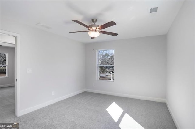 empty room featuring ceiling fan, carpet, and baseboards