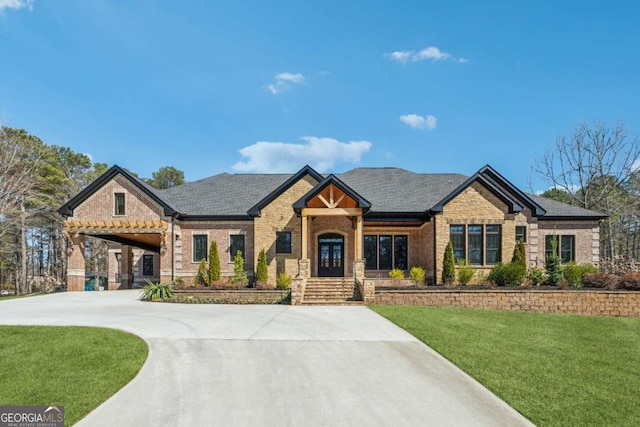 view of front facade with driveway, a front lawn, french doors, and brick siding