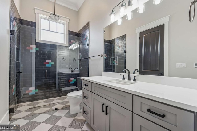 bathroom with ornamental molding, a stall shower, vanity, and toilet