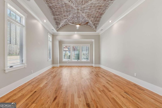 spare room featuring brick ceiling, recessed lighting, and baseboards