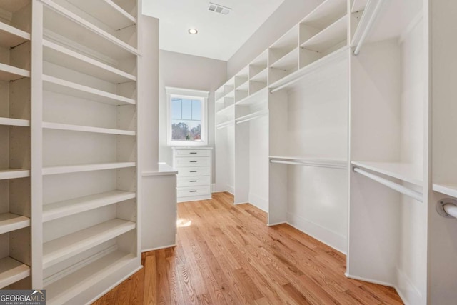 spacious closet featuring visible vents and wood finished floors