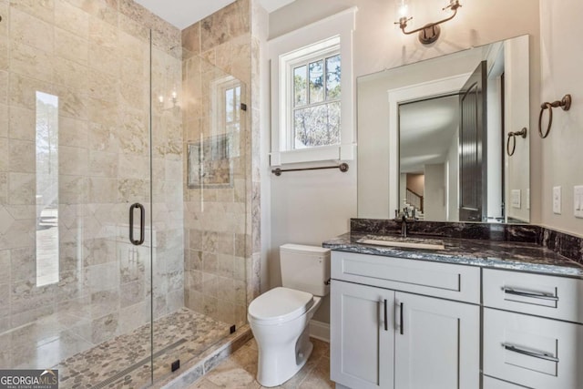 full bathroom featuring a stall shower, vanity, toilet, and tile patterned floors