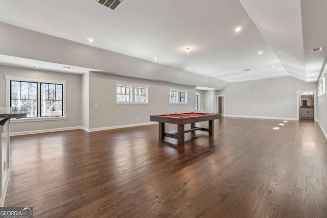 recreation room with dark wood-type flooring, lofted ceiling, visible vents, and baseboards