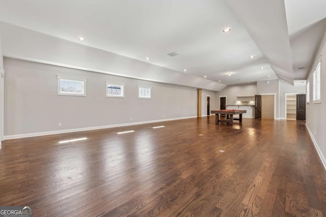 unfurnished living room with lofted ceiling, dark wood-style flooring, baseboards, and recessed lighting