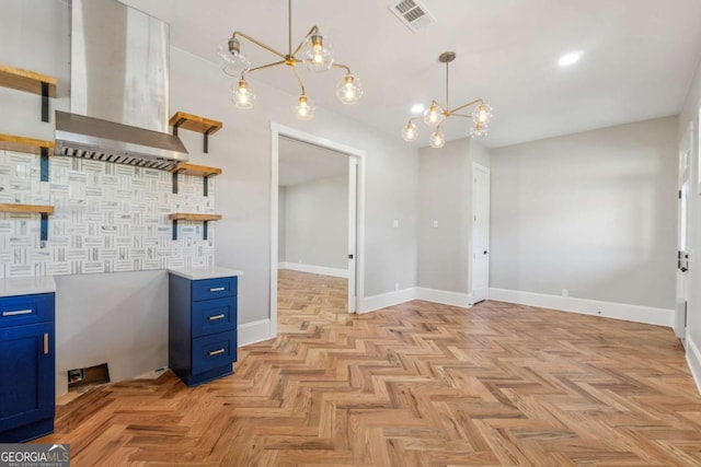 kitchen with open shelves, light countertops, visible vents, blue cabinets, and exhaust hood