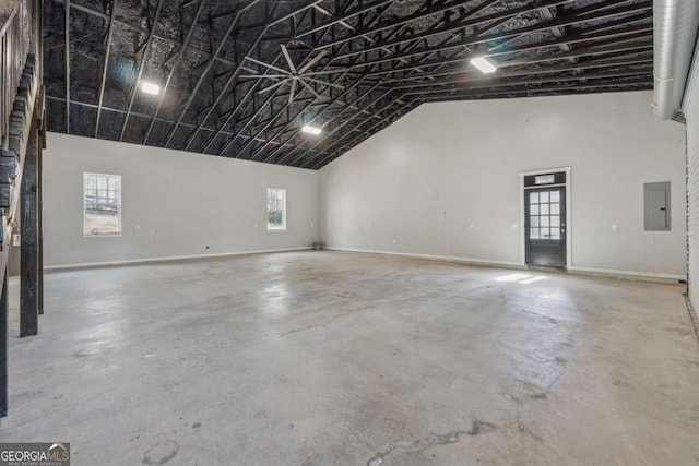 garage with electric panel and baseboards