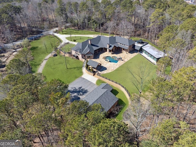 drone / aerial view with a wooded view