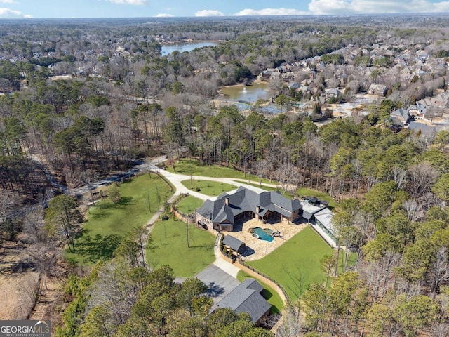 bird's eye view with a water view and a view of trees