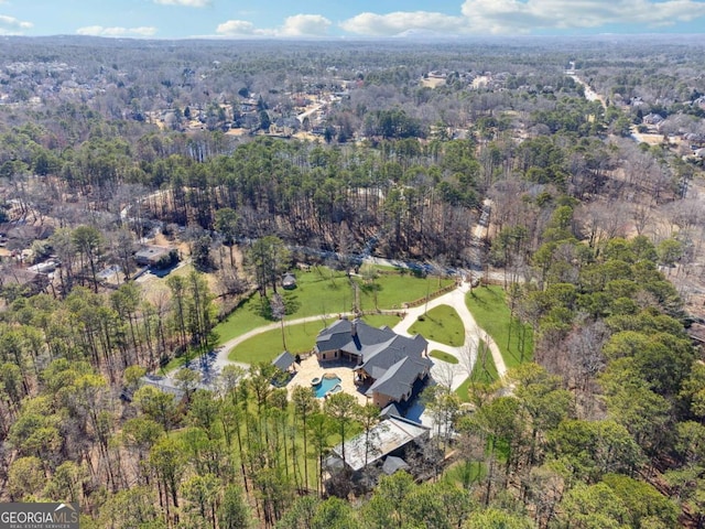 birds eye view of property with a view of trees