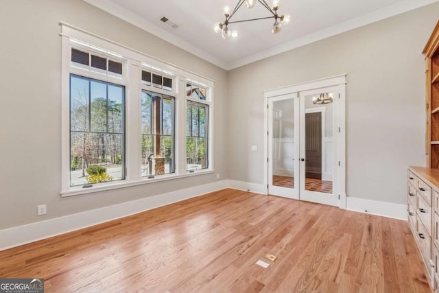 interior space featuring a chandelier, light wood-type flooring, and baseboards