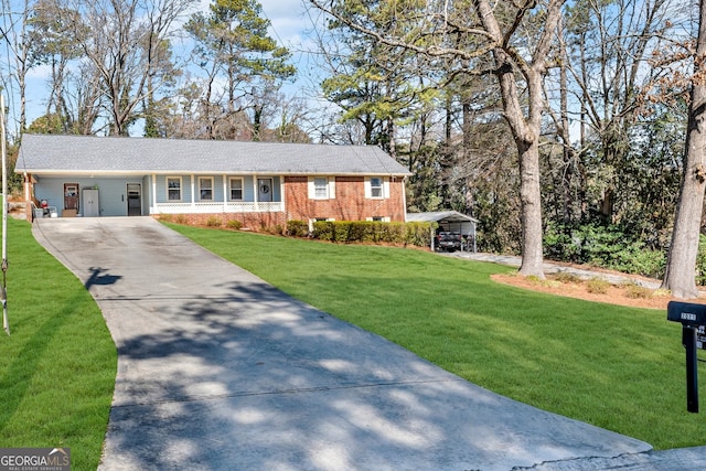 ranch-style house with a carport, concrete driveway, brick siding, and a front lawn