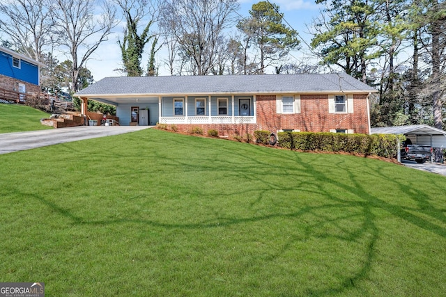 ranch-style house featuring driveway, a front lawn, a carport, and brick siding