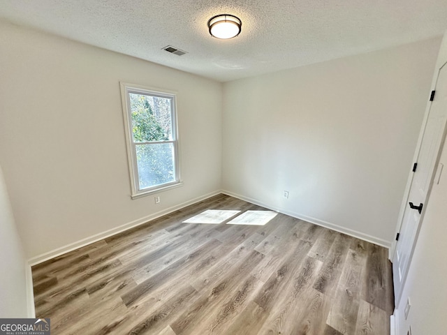 101 Summer Pond Trl, Lawrenceville, GA 30046 - empty room with wood finished floors, a textured ceiling, and baseboards