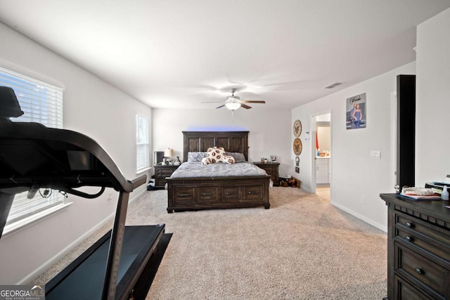 bedroom with a ceiling fan, light colored carpet, visible vents, and baseboards