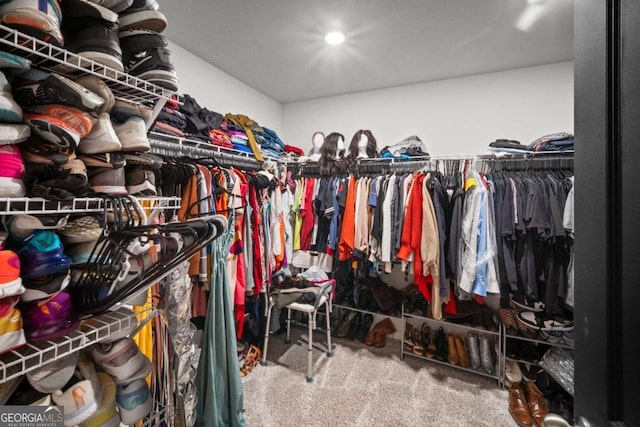 walk in closet featuring carpet floors