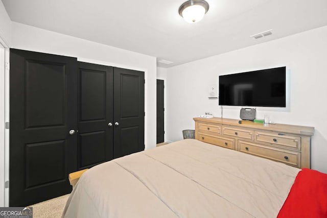 bedroom with a closet and visible vents