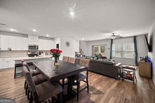 dining space with recessed lighting, ceiling fan, and light wood finished floors