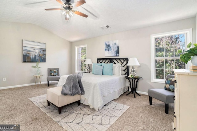 bedroom with baseboards, visible vents, light colored carpet, lofted ceiling, and a textured ceiling