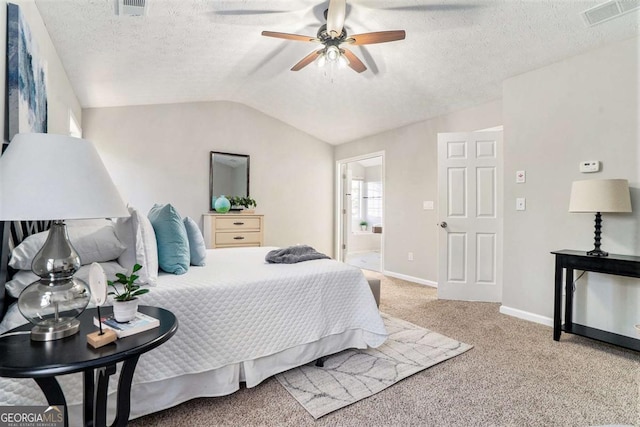 bedroom with a textured ceiling, light carpet, visible vents, baseboards, and vaulted ceiling