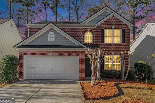 view of front facade featuring driveway, a garage, and brick siding