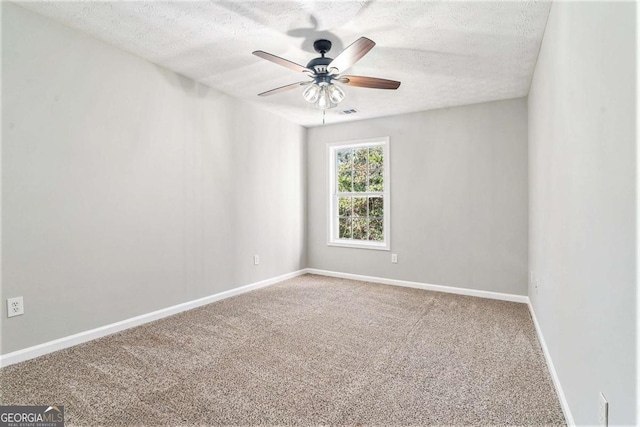 unfurnished room with carpet flooring, ceiling fan, a textured ceiling, and baseboards