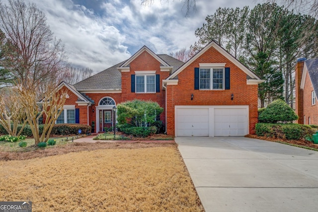 traditional home featuring concrete driveway, brick siding, an attached garage, and roof with shingles