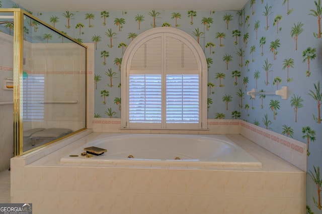 full bathroom featuring a whirlpool tub, wallpapered walls, and a shower stall