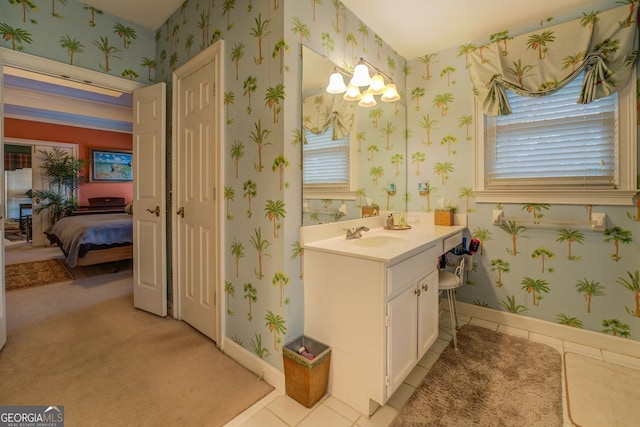 ensuite bathroom featuring tile patterned flooring, vanity, baseboards, ensuite bath, and wallpapered walls