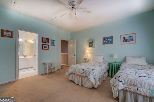 bedroom featuring carpet floors, attic access, ceiling fan, ensuite bath, and baseboards