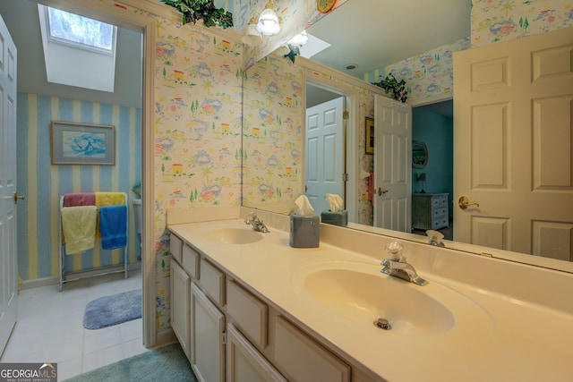 full bath with a skylight, tile patterned floors, a sink, and wallpapered walls