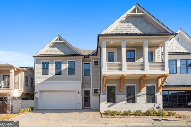 townhome / multi-family property featuring decorative driveway, an attached garage, and fence