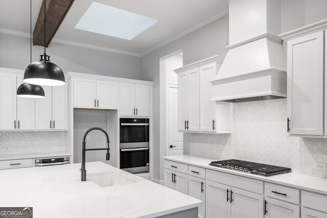 kitchen featuring dark wood-style floors, light countertops, appliances with stainless steel finishes, a kitchen island with sink, and premium range hood