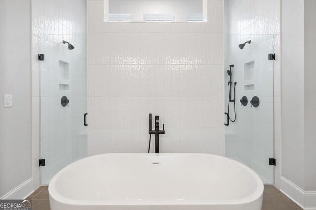 bathroom with double vanity, tile patterned flooring, a sink, and a walk in closet