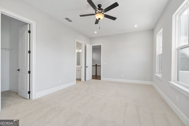 carpeted spare room with baseboards, a ceiling fan, and recessed lighting