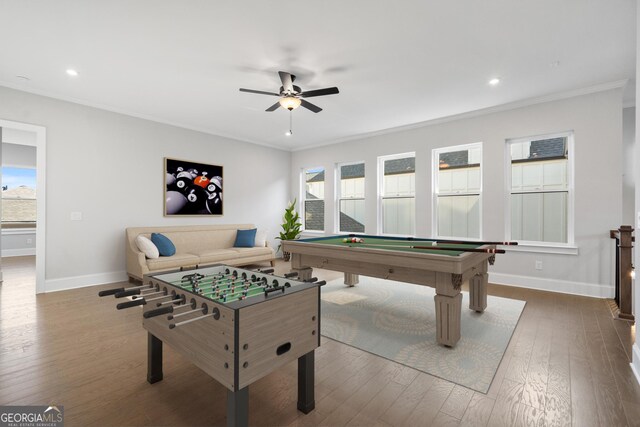 spare room featuring dark wood-style floors, crown molding, ceiling fan, and baseboards