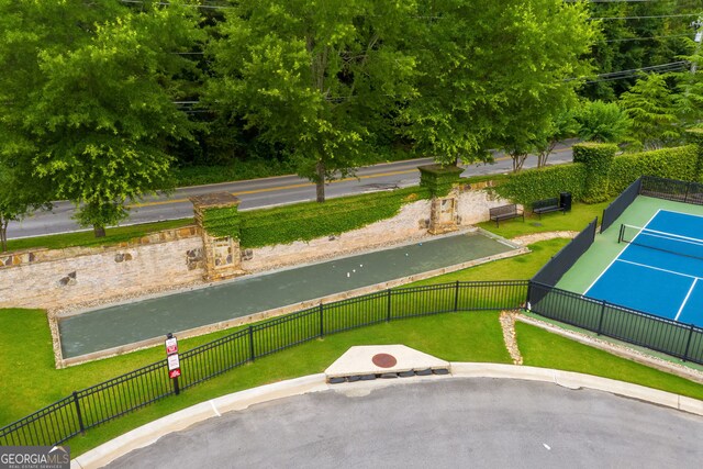 view of sport court featuring fence and a residential view