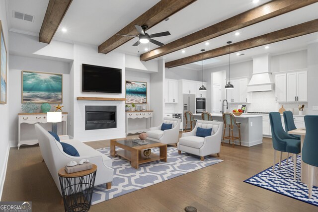 unfurnished living room with dark wood-style flooring, visible vents, a fireplace, and ceiling fan