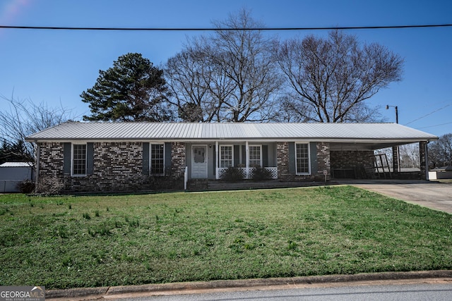 ranch-style home with metal roof, brick siding, driveway, a carport, and a front yard